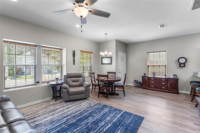 16887 Balmoral St, Montgomery, TX 77316 - living room with a chandelier, ceiling fan, and light wood finished floors