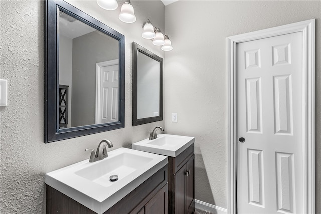 16887 Balmoral St, Montgomery, TX 77316 - bathroom featuring two vanities and a textured wall