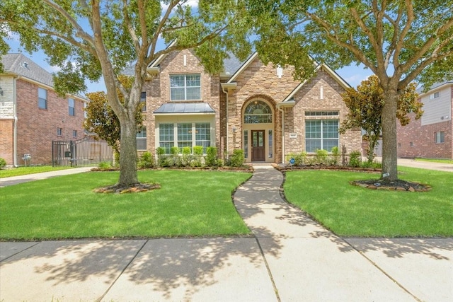5822 Bailey Springs Ct, Katy, TX 77450 - traditional home featuring brick siding, a gate, and stone siding