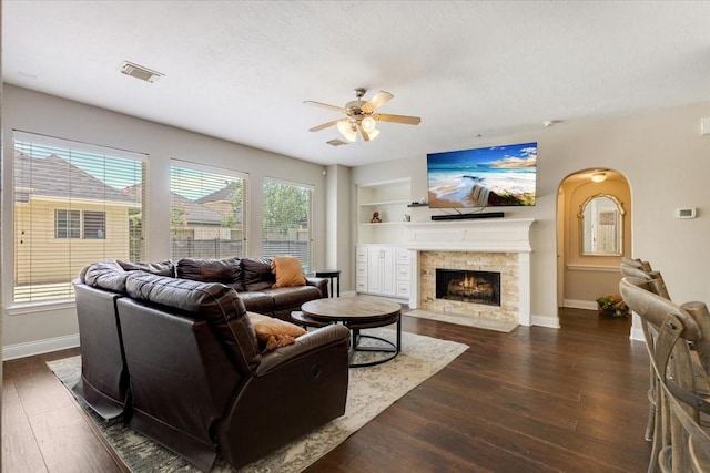 5822 Bailey Springs Ct, Katy, TX 77450 - living room with ceiling fan, dark wood-style floors, a fireplace, and built in shelves