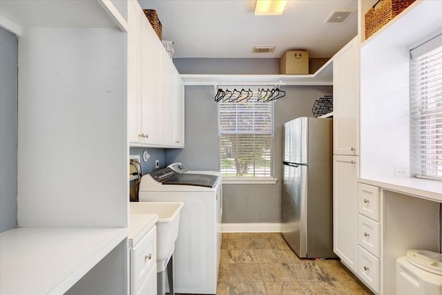 5822 Bailey Springs Ct, Katy, TX 77450 - laundry area featuring cabinet space and separate washer and dryer