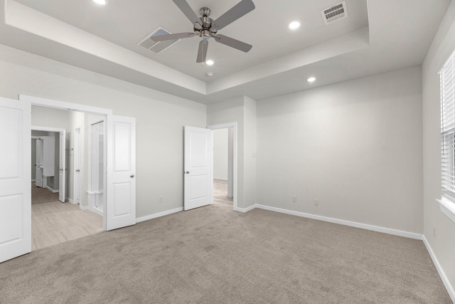 21624 Alberta Forest Cir, Magnolia, TX 77355 - unfurnished bedroom featuring light colored carpet, a raised ceiling, recessed lighting, and a ceiling fan