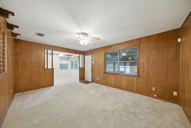 9506 Kell Cir, Houston, TX 77040 - empty room featuring a ceiling fan, wooden walls, carpet flooring, and a textured ceiling