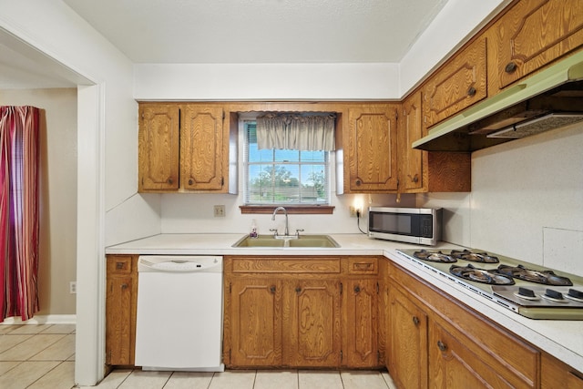 9506 Kell Cir, Houston, TX 77040 - kitchen with white dishwasher, gas stovetop, under cabinet range hood, stainless steel microwave, and brown cabinetry