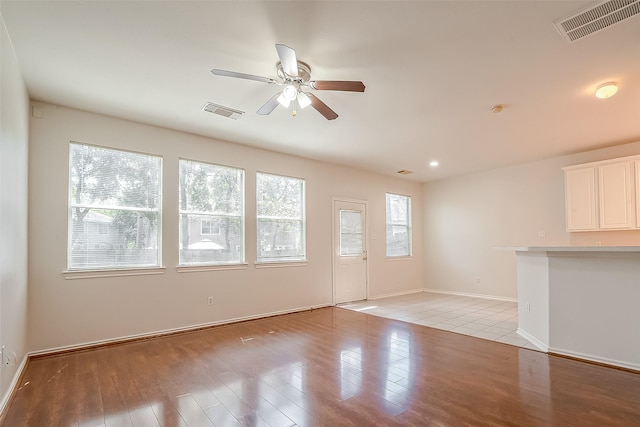 14 Scenic Brook Ct, The Woodlands, TX 77382 - unfurnished living room with ceiling fan and light wood-style flooring