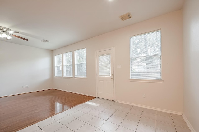 14 Scenic Brook Ct, The Woodlands, TX 77382 - empty room with a ceiling fan and light tile patterned floors
