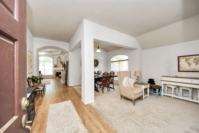 70 N Lace Arbor Dr, The Woodlands, TX 77382 - living area featuring wood finished floors, a fireplace, and arched walkways