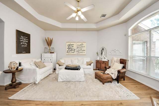 70 N Lace Arbor Dr, The Woodlands, TX 77382 - living area featuring a raised ceiling, wood finished floors, and ceiling fan