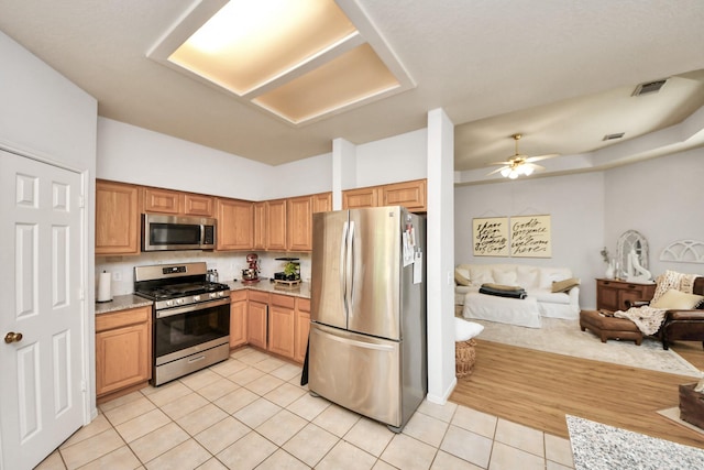 70 N Lace Arbor Dr, The Woodlands, TX 77382 - kitchen featuring stainless steel appliances, light tile patterned flooring, open floor plan, light countertops, and ceiling fan