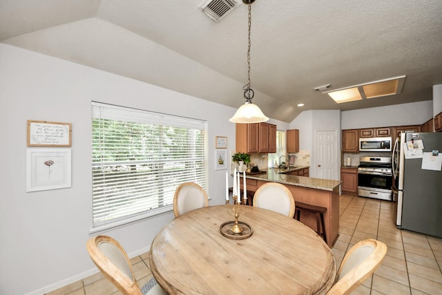 70 N Lace Arbor Dr, The Woodlands, TX 77382 - dining area with lofted ceiling and light tile patterned flooring