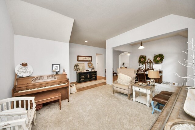70 N Lace Arbor Dr, The Woodlands, TX 77382 - living area featuring arched walkways, carpet flooring, and lofted ceiling
