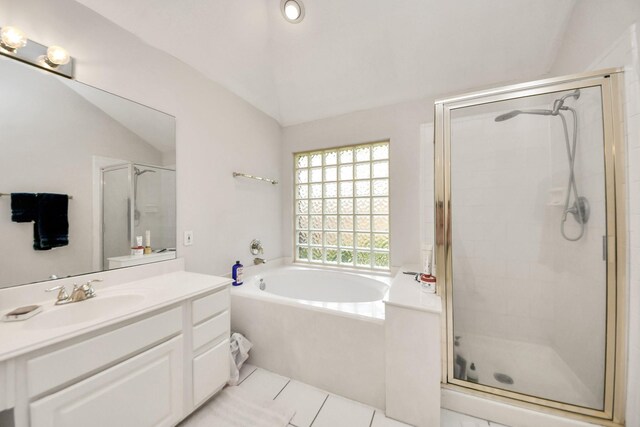 70 N Lace Arbor Dr, The Woodlands, TX 77382 - full bathroom featuring a garden tub, vaulted ceiling, vanity, a shower stall, and tile patterned flooring