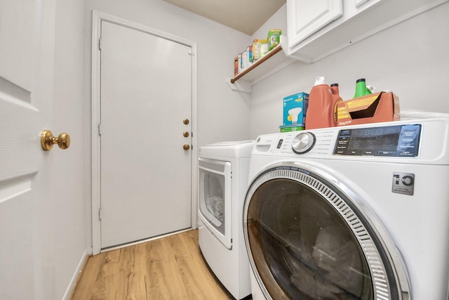 70 N Lace Arbor Dr, The Woodlands, TX 77382 - washroom with cabinet space, light wood-type flooring, and washing machine and dryer