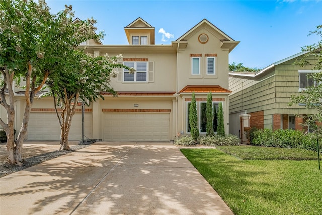 4006 Lanark Ln, Houston, TX 77025 - townhome / multi-family property with stucco siding, driveway, a front lawn, and a garage