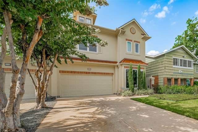 4006 Lanark Ln, Houston, TX 77025 - view of property featuring a garage, stucco siding, and concrete driveway