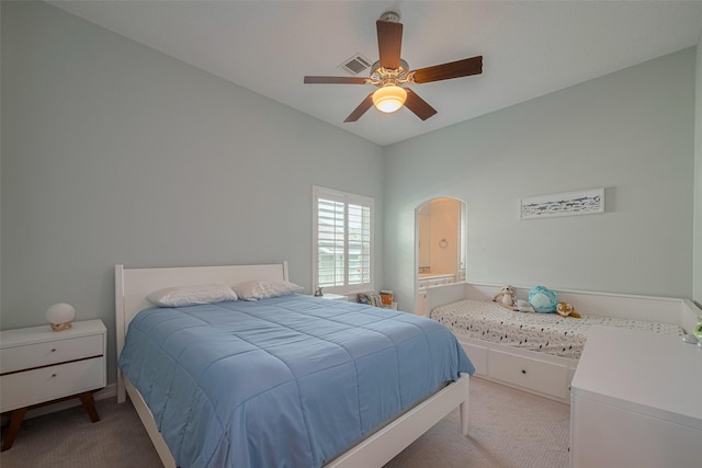 4006 Lanark Ln, Houston, TX 77025 - carpeted bedroom featuring arched walkways, ceiling fan, and ensuite bathroom
