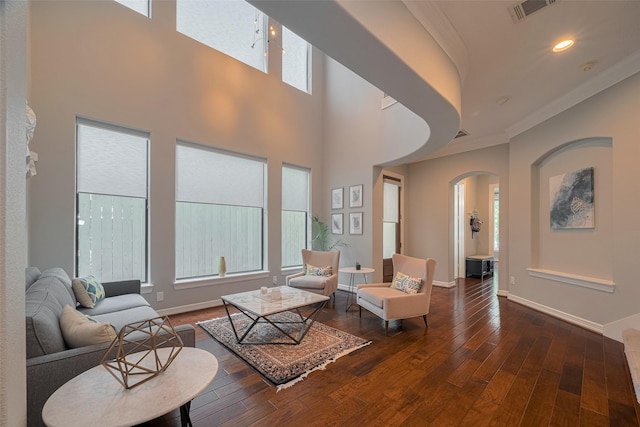 4006 Lanark Ln, Houston, TX 77025 - living room featuring arched walkways, wood-type flooring, crown molding, and recessed lighting