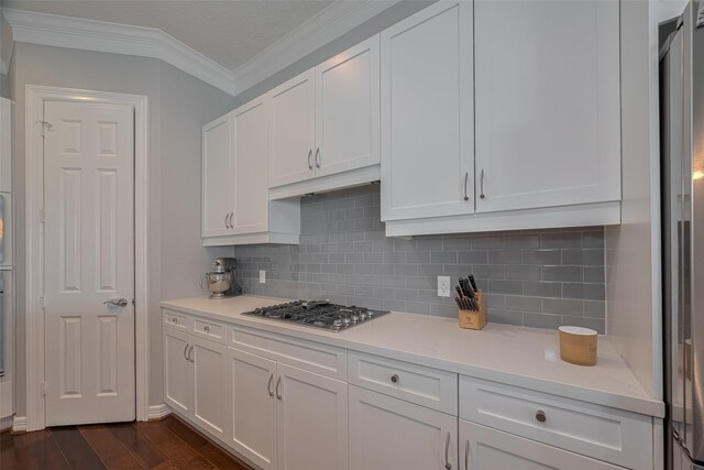 4006 Lanark Ln, Houston, TX 77025 - kitchen with stainless steel gas stovetop, white cabinetry, crown molding, light countertops, and backsplash