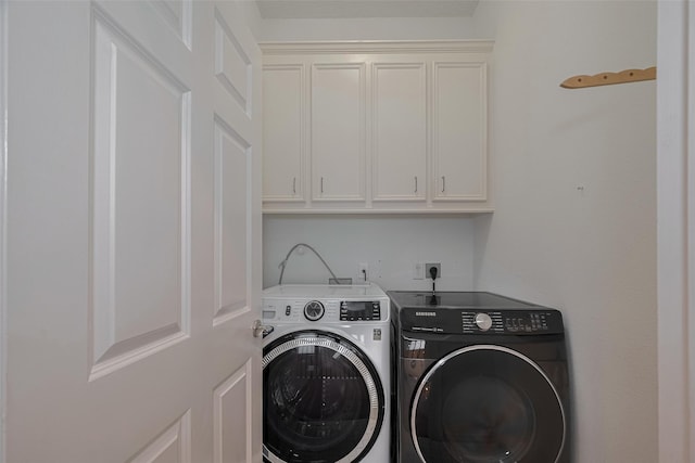 4006 Lanark Ln, Houston, TX 77025 - laundry room featuring washer and clothes dryer and cabinet space