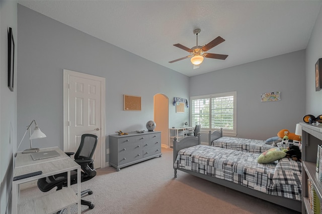 4006 Lanark Ln, Houston, TX 77025 - bedroom featuring light colored carpet, an office area, ceiling fan, and arched walkways