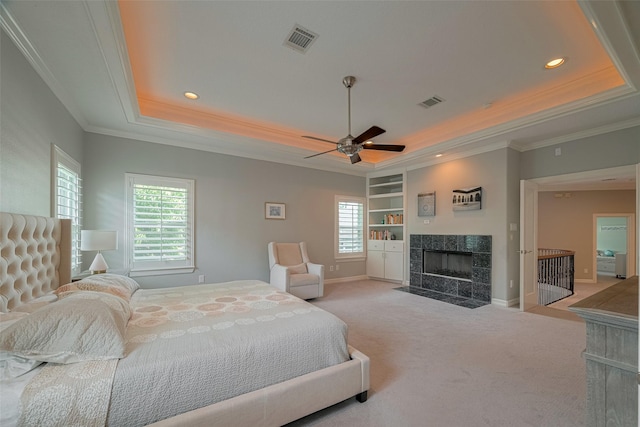 4006 Lanark Ln, Houston, TX 77025 - bedroom featuring a tray ceiling, crown molding, light carpet, multiple windows, and a fireplace