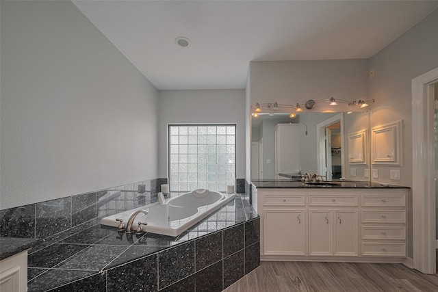 4006 Lanark Ln, Houston, TX 77025 - full bath with vanity, a garden tub, and wood finished floors