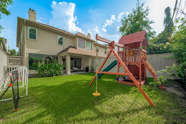 4006 Lanark Ln, Houston, TX 77025 - rear view of property featuring a playground, a fenced backyard, a chimney, stucco siding, and a patio