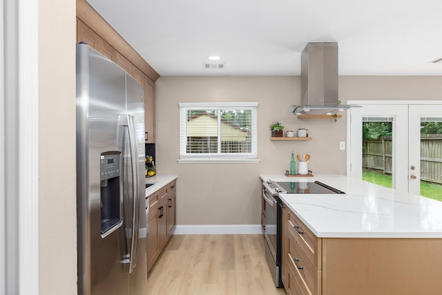 2807 Canary Ln, Humble, TX 77396 - kitchen with stainless steel appliances, island exhaust hood, a peninsula, french doors, and light wood-style flooring