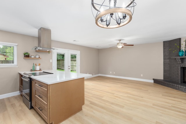 2807 Canary Ln, Humble, TX 77396 - kitchen featuring stainless steel electric range, extractor fan, healthy amount of natural light, and light wood finished floors