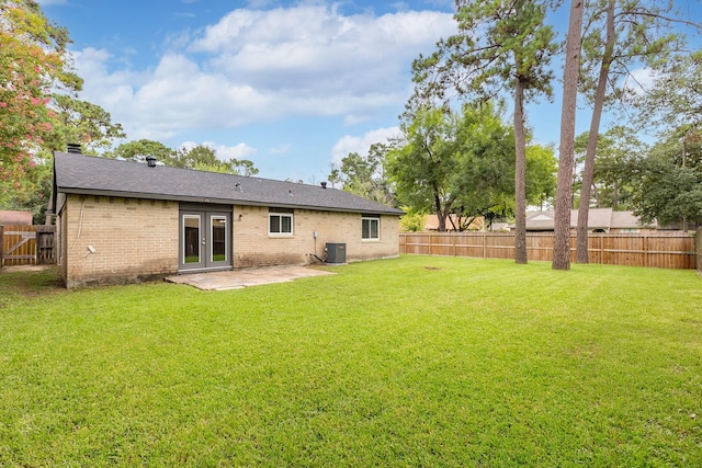2807 Canary Ln, Humble, TX 77396 - back of property with french doors, a fenced backyard, a patio, brick siding, and roof with shingles