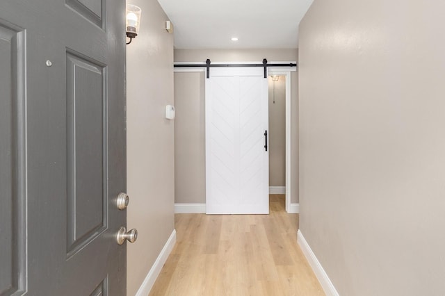 2807 Canary Ln, Humble, TX 77396 - hall featuring light wood-style flooring, a barn door, and recessed lighting