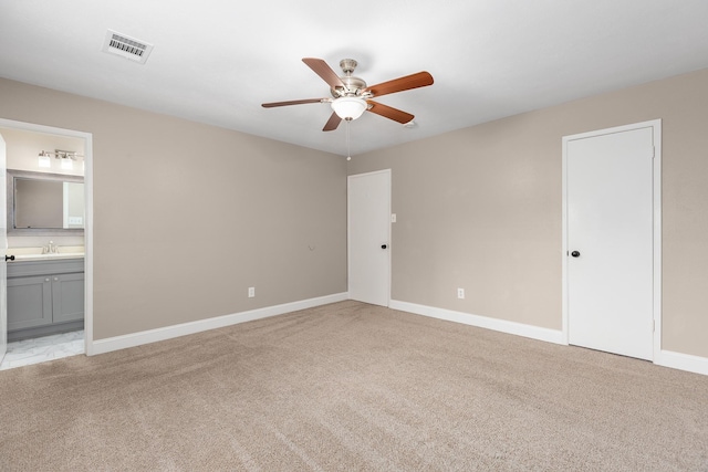 2807 Canary Ln, Humble, TX 77396 - unfurnished bedroom featuring light colored carpet, ensuite bath, and a ceiling fan