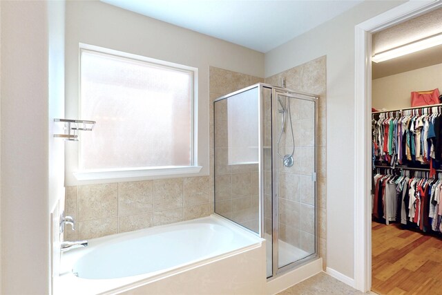 17315 Cumberland Park Ln, Humble, TX 77346 - bathroom featuring a garden tub, a stall shower, and a spacious closet