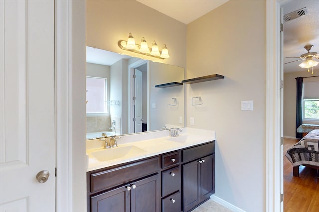 17315 Cumberland Park Ln, Humble, TX 77346 - ensuite bathroom featuring double vanity, a ceiling fan, a bath, and wood finished floors
