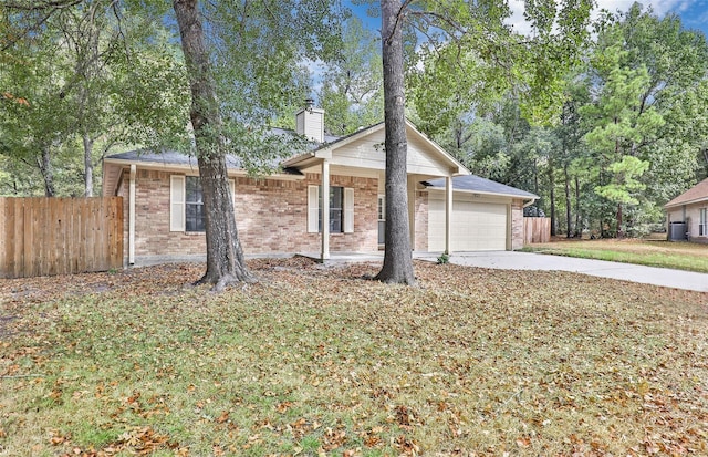 507 Odessa Dr, Magnolia, TX 77354 - ranch-style house featuring a chimney, an attached garage, driveway, and brick siding