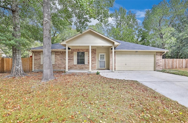 507 Odessa Dr, Magnolia, TX 77354 - ranch-style house featuring a garage, driveway, a porch, and brick siding