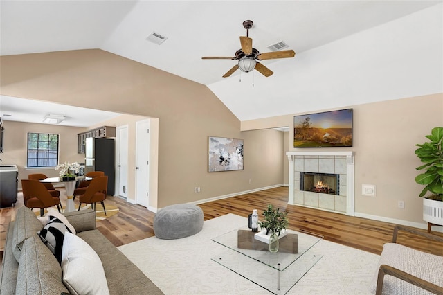 507 Odessa Dr, Magnolia, TX 77354 - living area with ceiling fan, light wood-style flooring, vaulted ceiling, and a fireplace