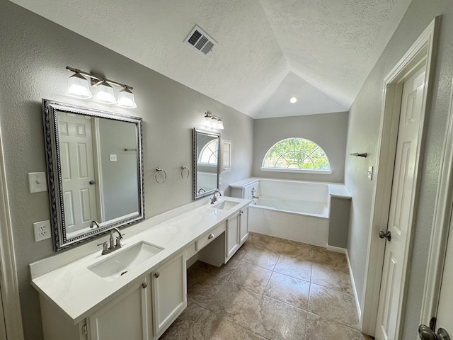 4607 Blue Rose Cir, Missouri City, TX 77459 - bathroom with lofted ceiling, double vanity, a bath, a textured ceiling, and tile patterned flooring