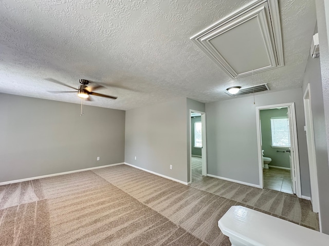 4607 Blue Rose Cir, Missouri City, TX 77459 - carpeted spare room featuring attic access, a ceiling fan, and a textured ceiling