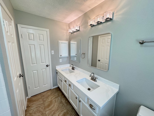 4607 Blue Rose Cir, Missouri City, TX 77459 - bathroom featuring double vanity and a textured ceiling