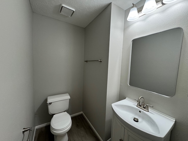 4607 Blue Rose Cir, Missouri City, TX 77459 - half bathroom featuring wood finished floors, vanity, and a textured ceiling
