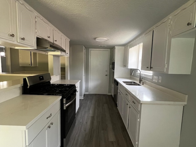 7726 Ashmole Ln, Houston, TX 77088 - kitchen featuring stainless steel appliances, under cabinet range hood, a textured ceiling, dark wood-style flooring, and white cabinetry
