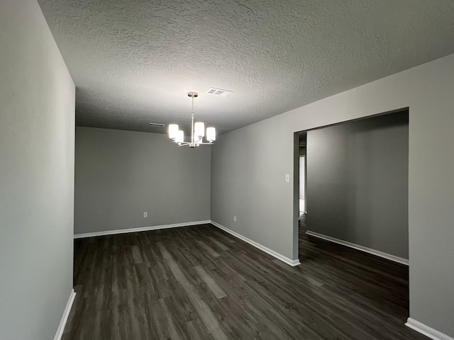 7726 Ashmole Ln, Houston, TX 77088 - empty room featuring a chandelier, dark wood-type flooring, and a textured ceiling