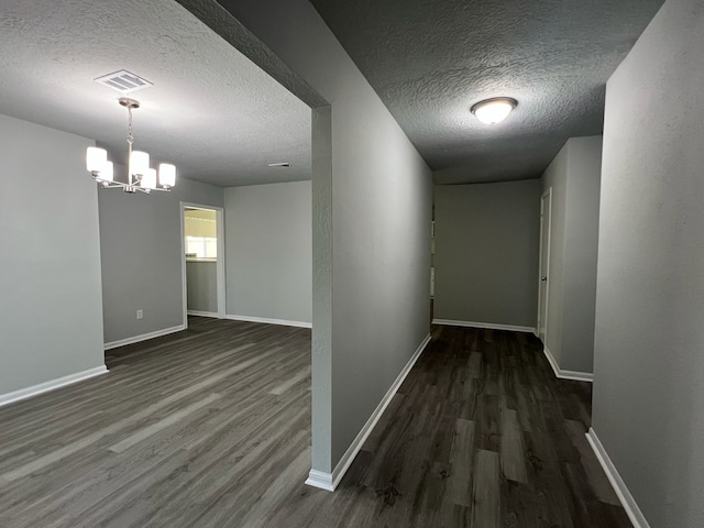 7726 Ashmole Ln, Houston, TX 77088 - corridor featuring a textured ceiling, wood finished floors, and a chandelier