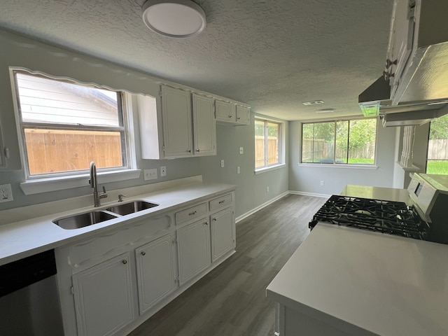 7726 Ashmole Ln, Houston, TX 77088 - kitchen featuring stainless steel appliances, dark wood-style floors, light countertops, a textured ceiling, and white cabinets