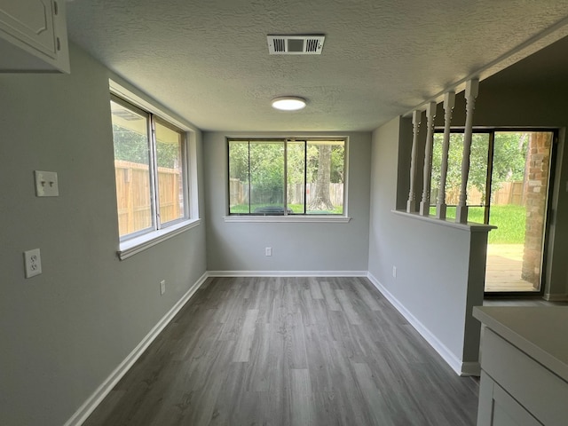 7726 Ashmole Ln, Houston, TX 77088 - spare room with dark wood-style flooring and a textured ceiling