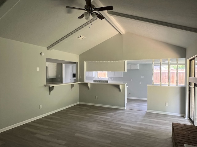 7726 Ashmole Ln, Houston, TX 77088 - unfurnished living room with healthy amount of natural light, dark wood-style flooring, ceiling fan, and a textured ceiling