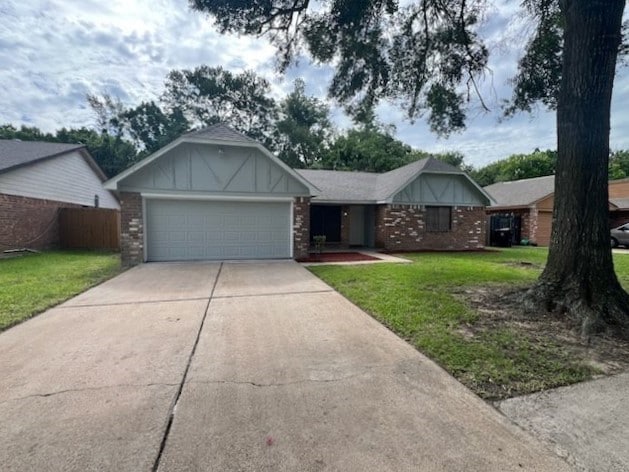 7726 Ashmole Ln, Houston, TX 77088 - ranch-style house featuring driveway, a garage, and brick siding