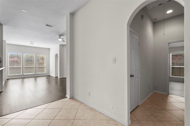 11047 Pierce Valley Dr, Richmond, TX 77406 - empty room featuring a ceiling fan, arched walkways, and light tile patterned floors
