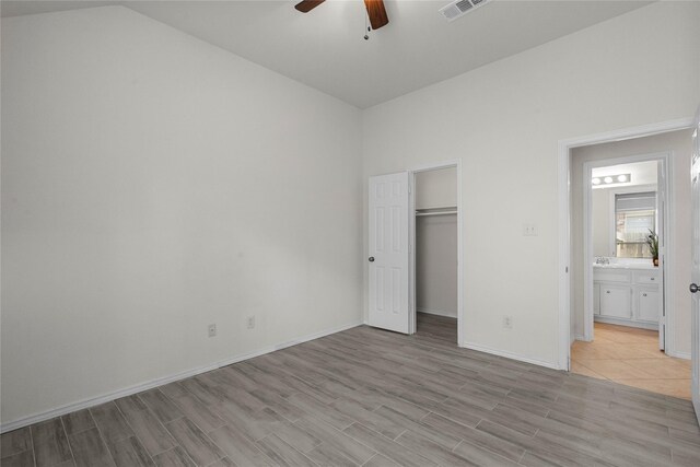 11047 Pierce Valley Dr, Richmond, TX 77406 - unfurnished bedroom featuring light wood-style floors, vaulted ceiling, ceiling fan, and a closet